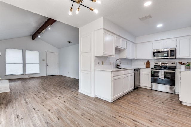 kitchen featuring decorative backsplash, visible vents, light countertops, light wood finished floors, and stainless steel appliances