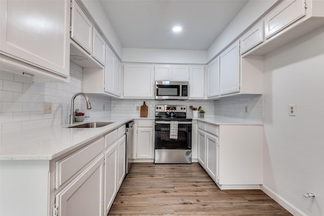kitchen with white cabinetry, appliances with stainless steel finishes, and a sink