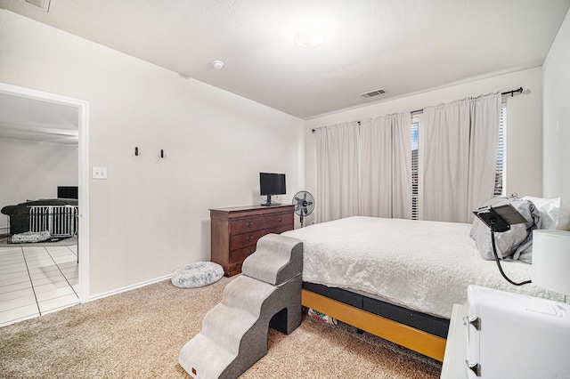 carpeted bedroom with visible vents and baseboards