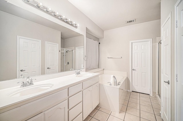 bathroom with visible vents, a sink, tile patterned flooring, and a stall shower