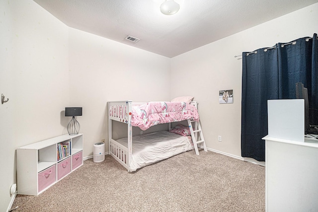 bedroom with baseboards, carpet, and visible vents