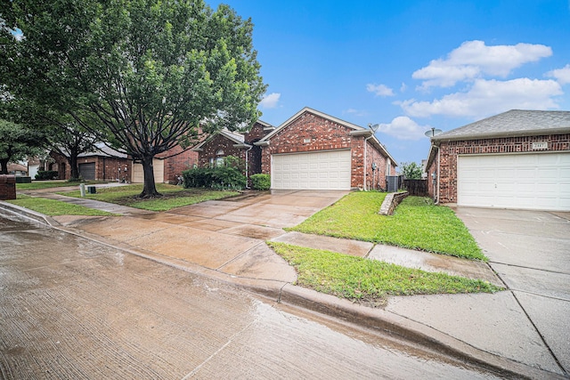 view of front facade with driveway, a garage, brick siding, fence, and a front lawn