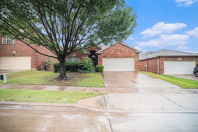 view of front of house featuring brick siding, driveway, a front yard, and a garage