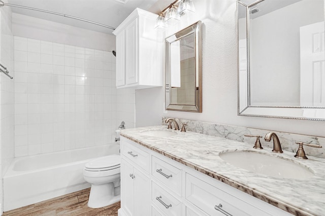 full bathroom featuring toilet, shower / washtub combination, a sink, and wood finished floors