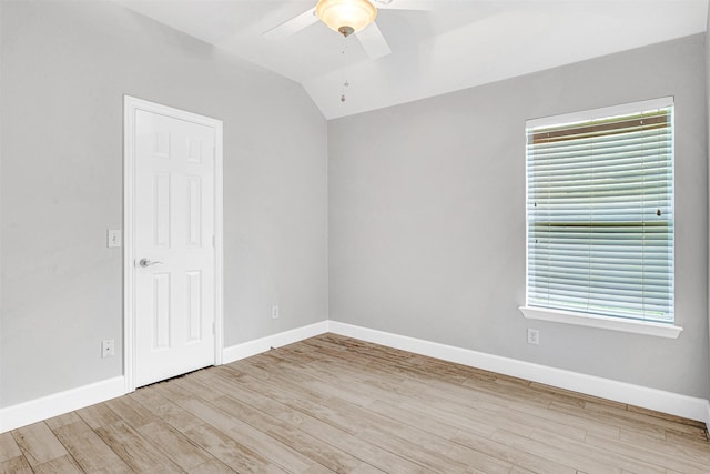 unfurnished room featuring baseboards, ceiling fan, wood finished floors, and a healthy amount of sunlight