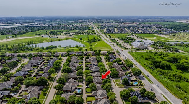 drone / aerial view featuring a water view and a residential view