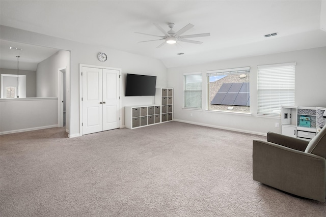 carpeted living area with baseboards, a ceiling fan, and visible vents