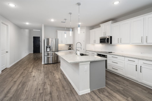 kitchen with stainless steel appliances, decorative backsplash, a sink, and dark wood-type flooring