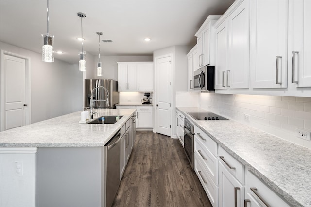 5604 Deer Run Dr, Celina, TX 75009 - kitchen with a sink, dark wood finished floors, white cabinets, and stainless steel appliances