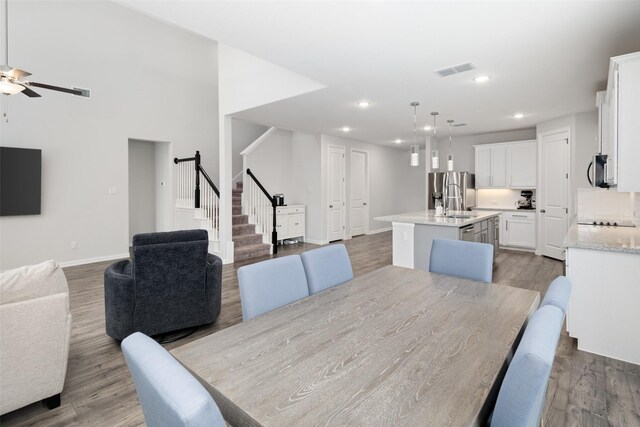 dining room with baseboards and wood finished floors