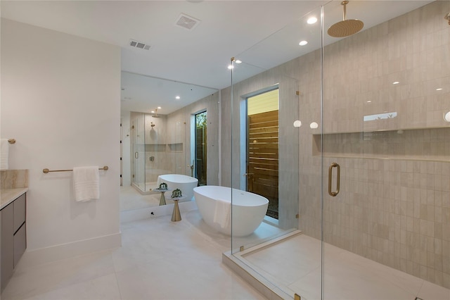 full bathroom featuring a freestanding tub, tile patterned flooring, a stall shower, and visible vents