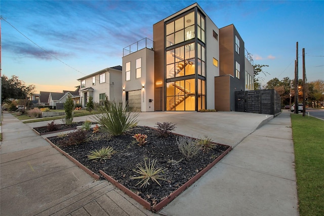 view of front facade featuring a garage, stucco siding, and concrete driveway