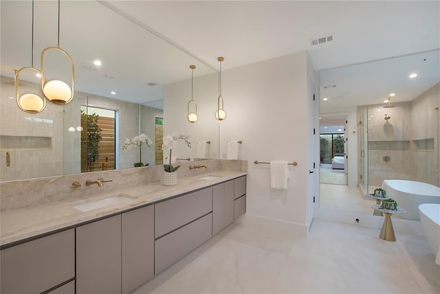 bathroom featuring double vanity, visible vents, a sink, and a shower with shower door