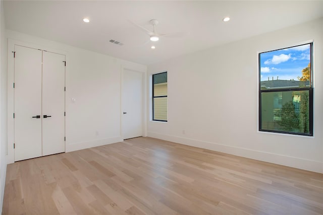 unfurnished bedroom with recessed lighting, light wood-style flooring, and visible vents