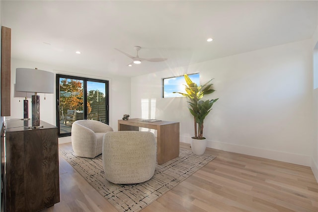 living room with light wood-style floors, recessed lighting, and baseboards
