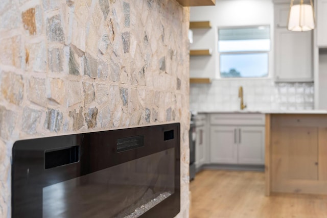 1900 County Road 1255, Savoy, TX 75479 - kitchen with light countertops, a sink, light wood-style flooring, and tasteful backsplash