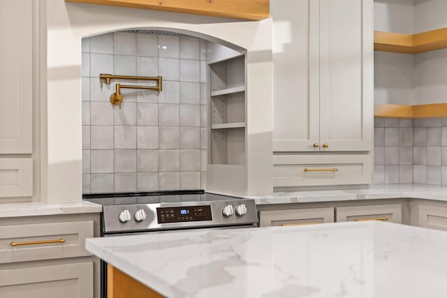 1900 County Road 1255, Savoy, TX 75479 - kitchen with open shelves, light stone countertops, electric stove, tasteful backsplash, and arched walkways