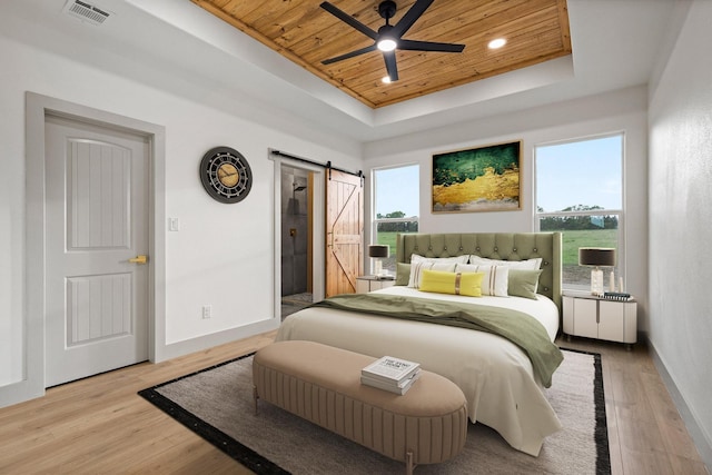 1900 County Road 1255, Savoy, TX 75479 - bedroom with visible vents, a barn door, wooden ceiling, baseboards, and a tray ceiling