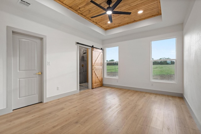 1900 County Road 1255, Savoy, TX 75479 - unfurnished bedroom featuring visible vents, a barn door, wooden ceiling, a raised ceiling, and baseboards