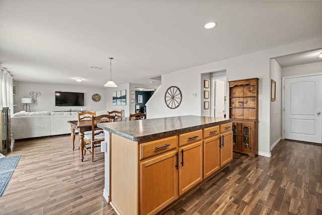 6336 Maritime St, Fort Worth, TX 76179 - kitchen featuring dark wood-type flooring, dark countertops, open floor plan, a center island, and recessed lighting