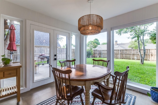 sunroom / solarium featuring french doors