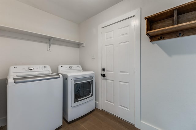 laundry area with laundry area, dark wood-style flooring, and washing machine and dryer