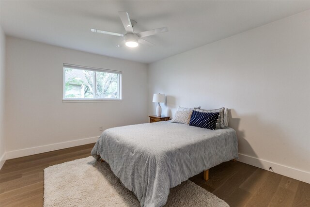 bedroom with baseboards, ceiling fan, and wood finished floors