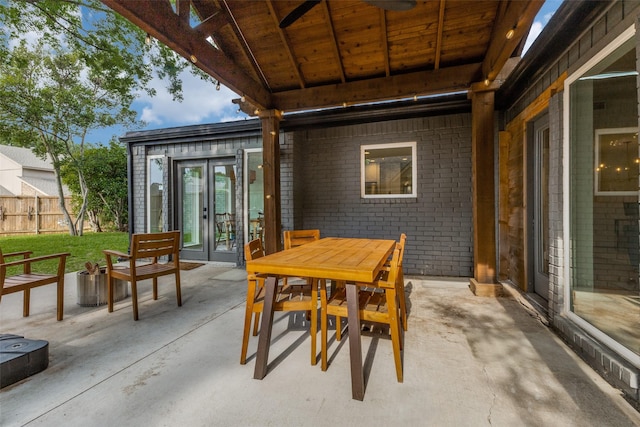 view of patio featuring fence and french doors
