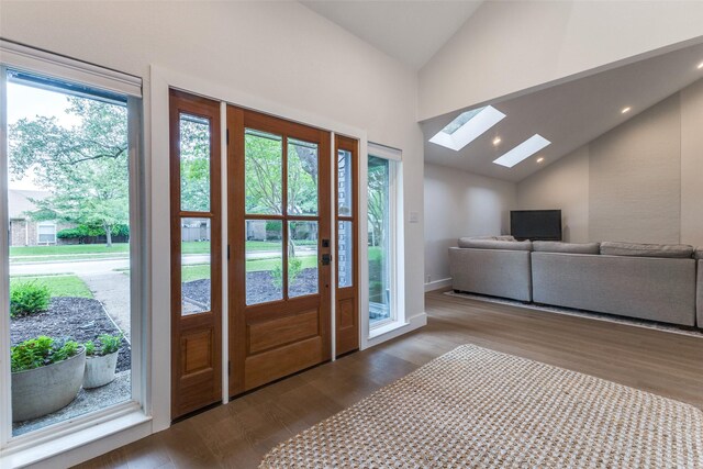 entryway featuring a skylight, high vaulted ceiling, baseboards, dark wood-style floors, and recessed lighting