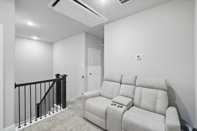 carpeted living room with attic access and recessed lighting