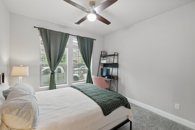 carpeted bedroom featuring baseboards, a ceiling fan, and visible vents