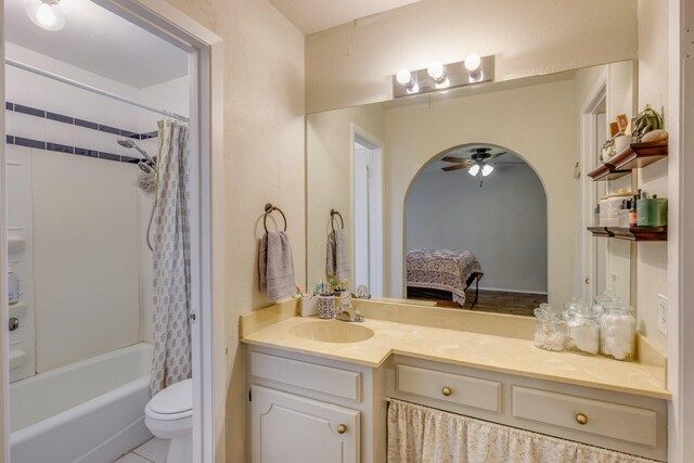 bathroom featuring vanity, toilet, ceiling fan, ensuite bath, and shower / tub combo
