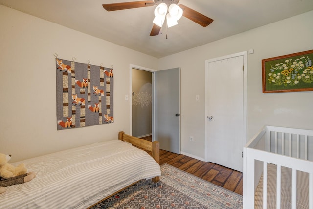 bedroom featuring baseboards, a ceiling fan, and wood finished floors