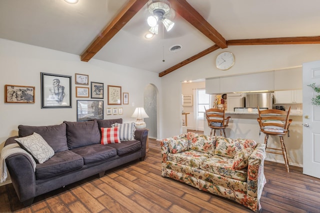living area with ceiling fan, visible vents, lofted ceiling with beams, and wood finished floors