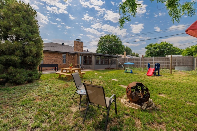 view of yard featuring a fenced backyard and a sunroom