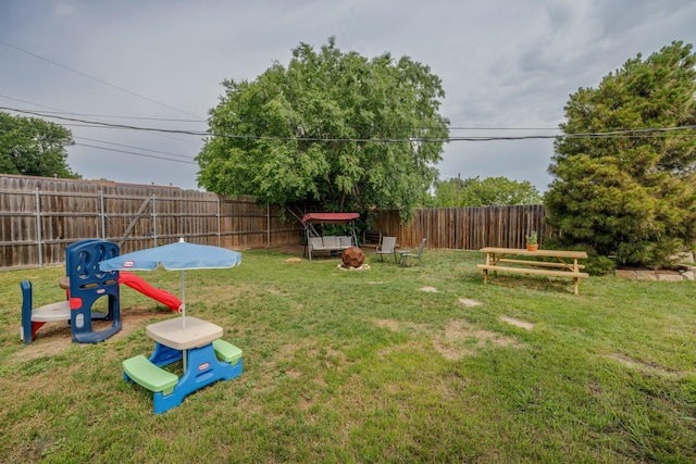 view of yard featuring a fenced backyard and an outdoor fire pit
