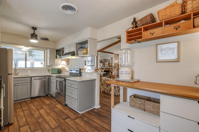 kitchen featuring gray cabinets, visible vents, appliances with stainless steel finishes, open shelves, and dark wood-type flooring