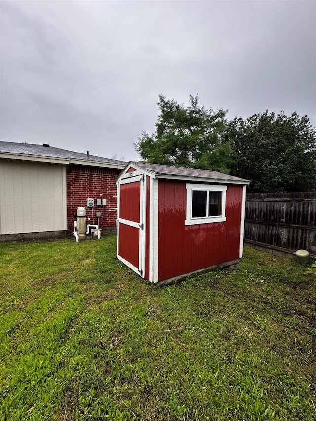 view of shed featuring fence