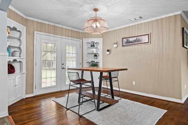 dining space with french doors, visible vents, built in features, and ornamental molding