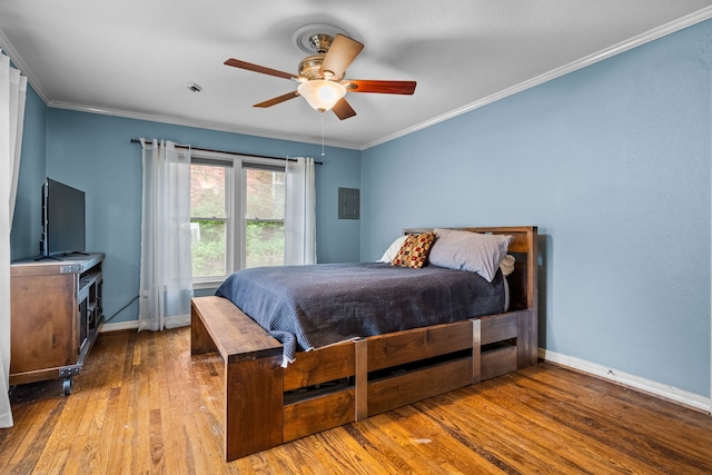 bedroom featuring wood-type flooring, a ceiling fan, baseboards, and ornamental molding