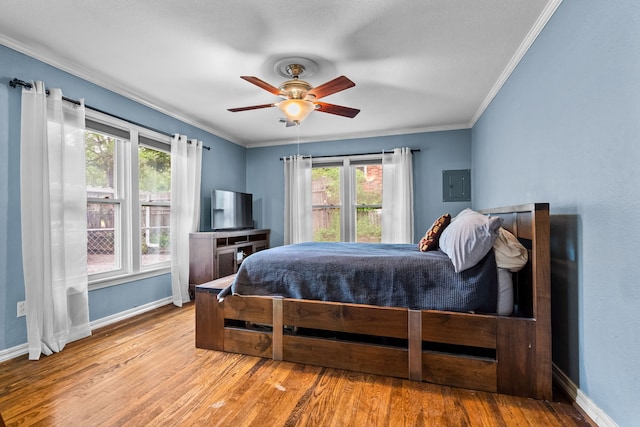 bedroom featuring crown molding, baseboards, and multiple windows