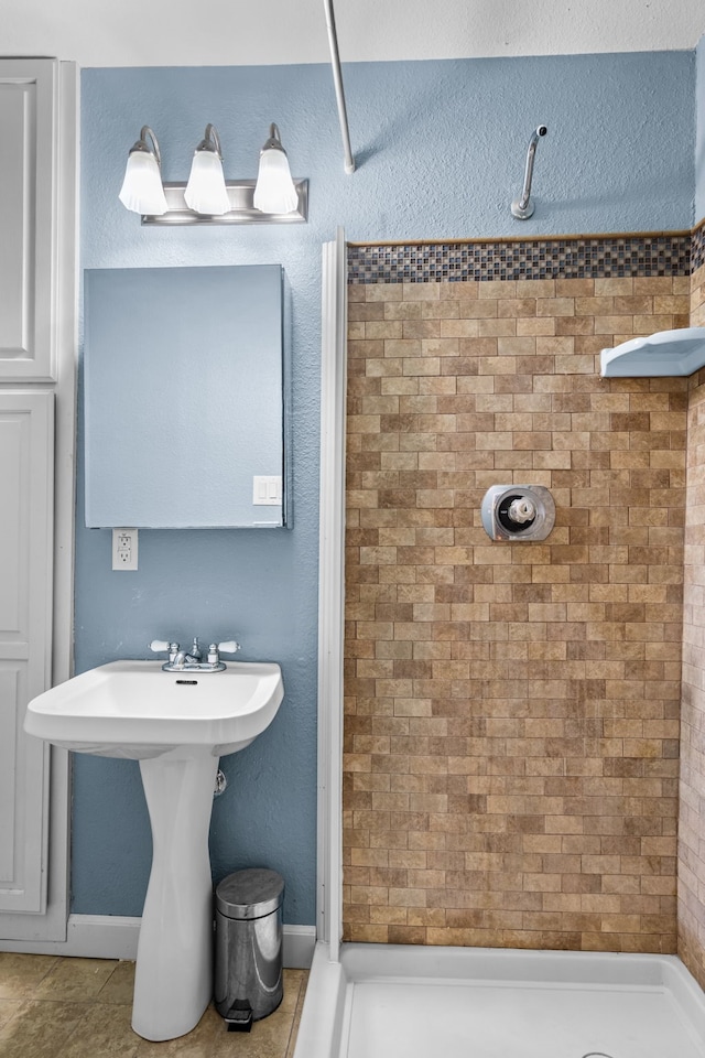bathroom with tile patterned floors and a stall shower