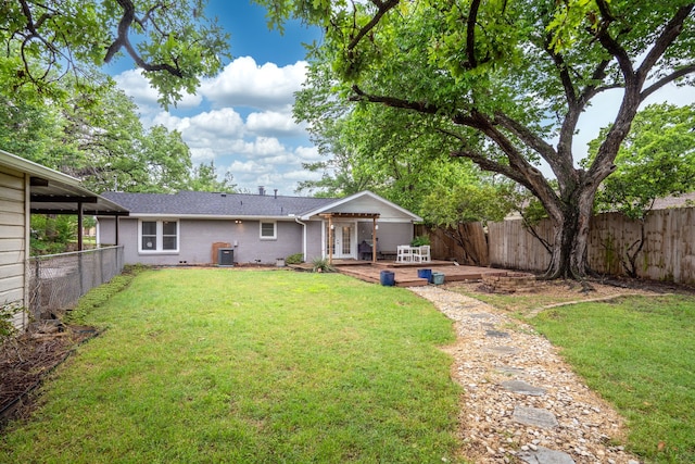 back of house with a deck, a fenced backyard, french doors, brick siding, and a yard