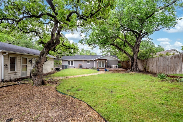 view of yard with a fenced backyard, a patio area, french doors, and cooling unit