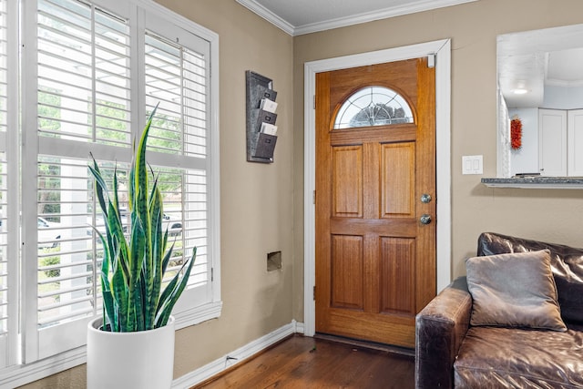 entryway with crown molding, baseboards, and dark wood-style floors
