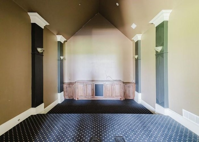 interior space with vaulted ceiling, visible vents, baseboards, and carpet