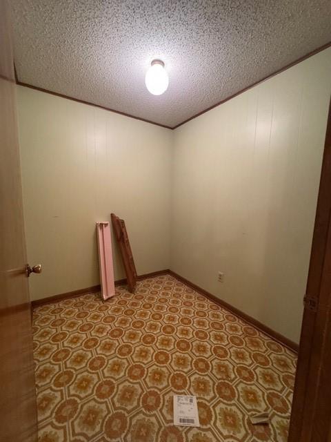 empty room featuring light floors and a textured ceiling