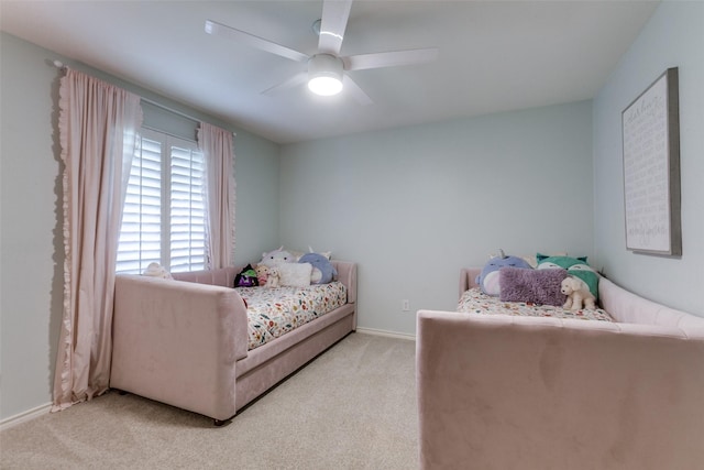 bedroom featuring ceiling fan, light colored carpet, and baseboards