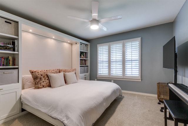 carpeted bedroom with baseboards and ceiling fan