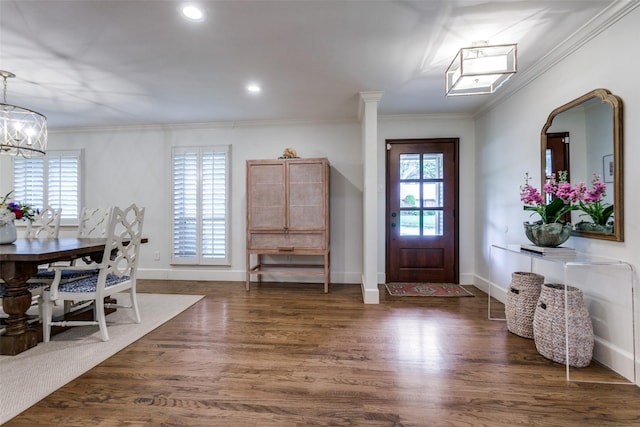 entryway with ornamental molding, wood finished floors, baseboards, recessed lighting, and a chandelier